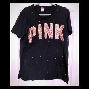 Pink tshirt with gold embellishments.